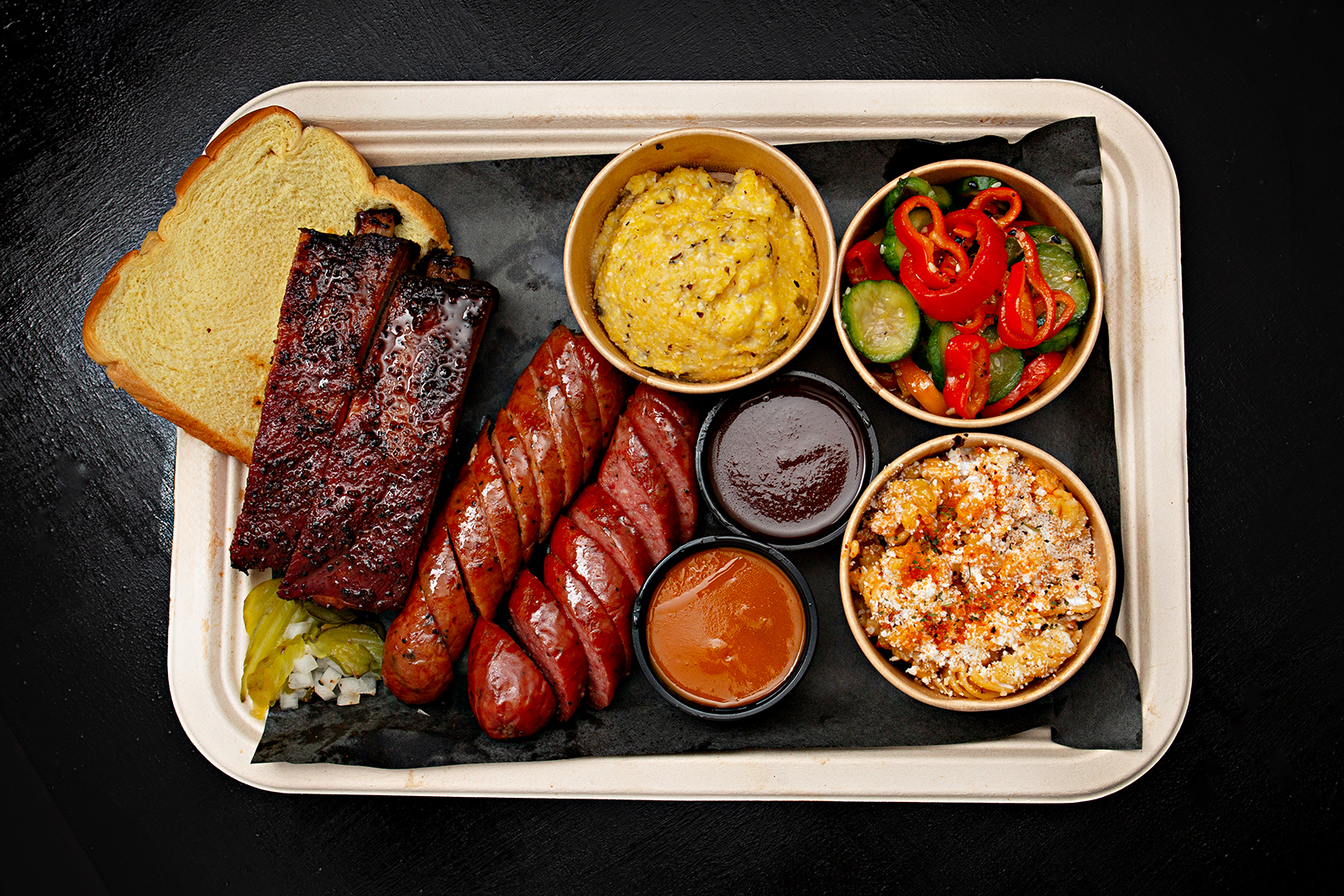 BBQ tray with ribs, sausage and sides